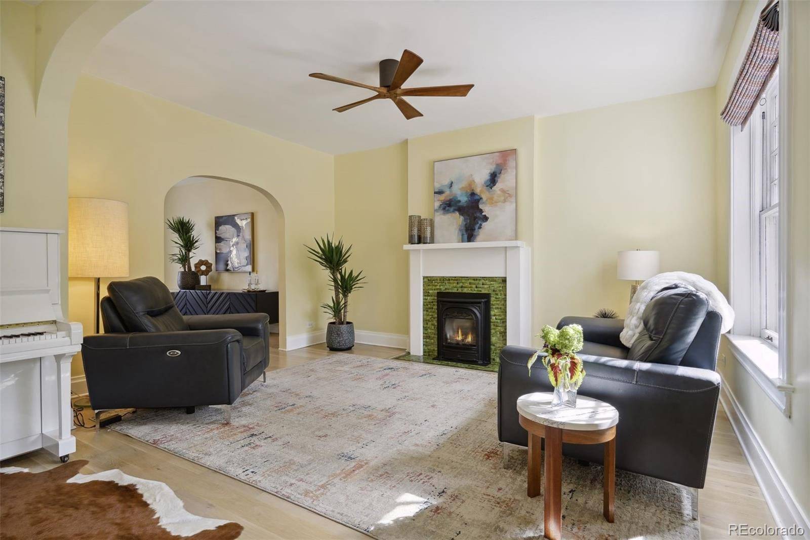 Living room with an original tiled fireplace in a Congress Park townhome sold by Pam Dunn