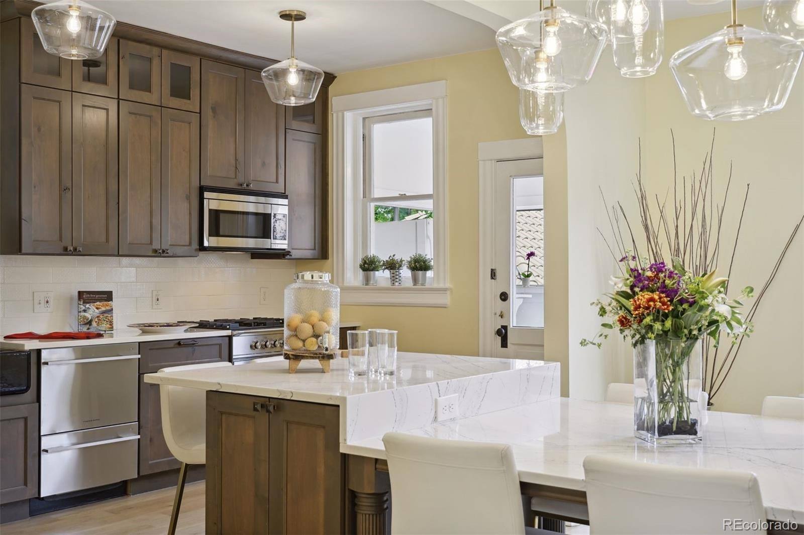 Kitchen with quartz island and stainless appliances