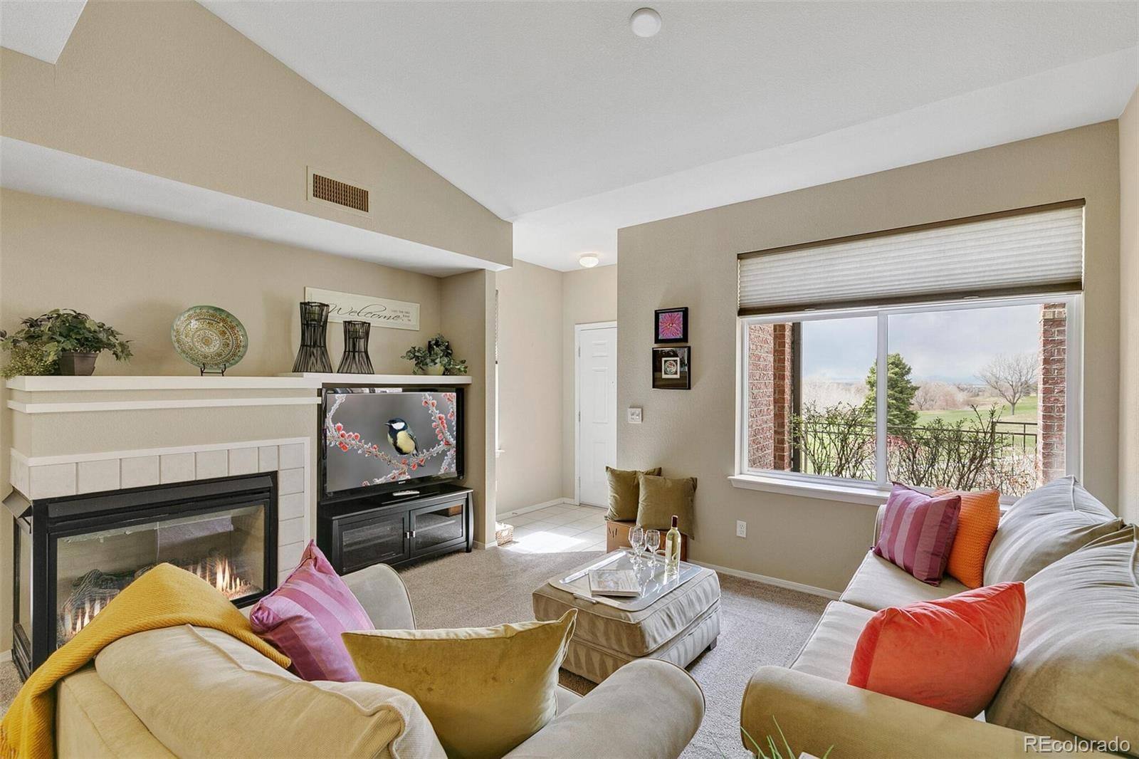 Living room with fireplace and golf-course view in Palomino Park