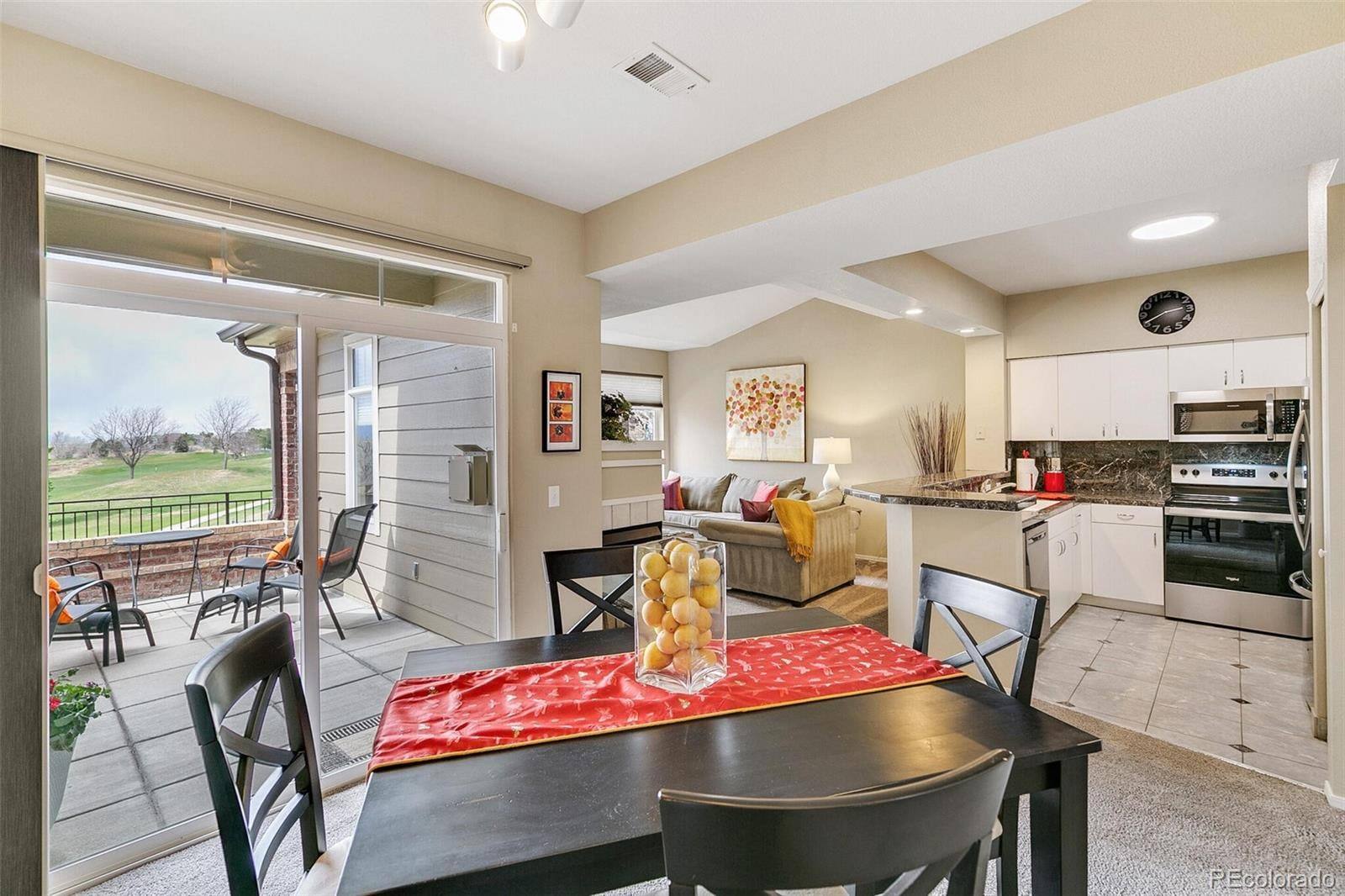 Dining area with patio access and course views