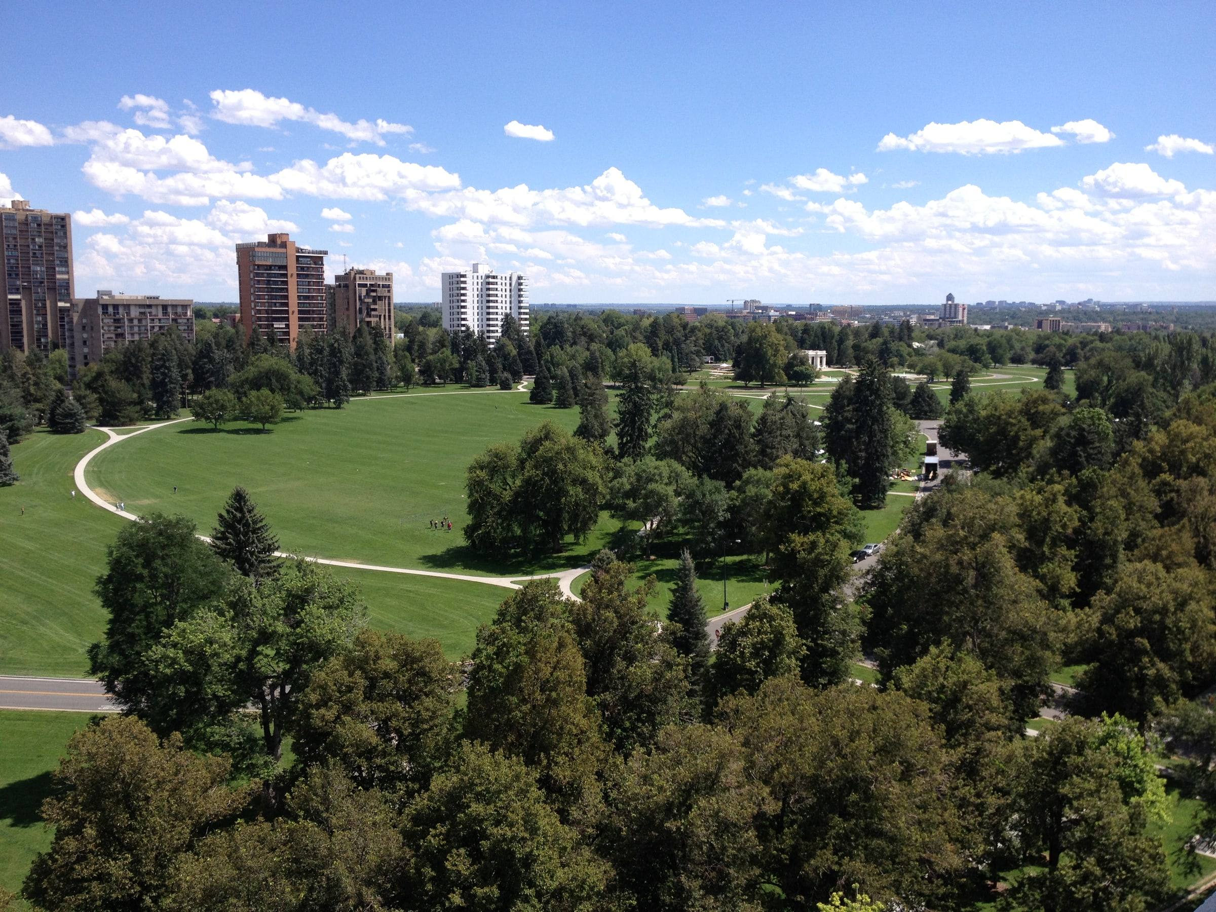 Cheesman Park lawns and paths seen from above, with Capitol Hill towers beyond