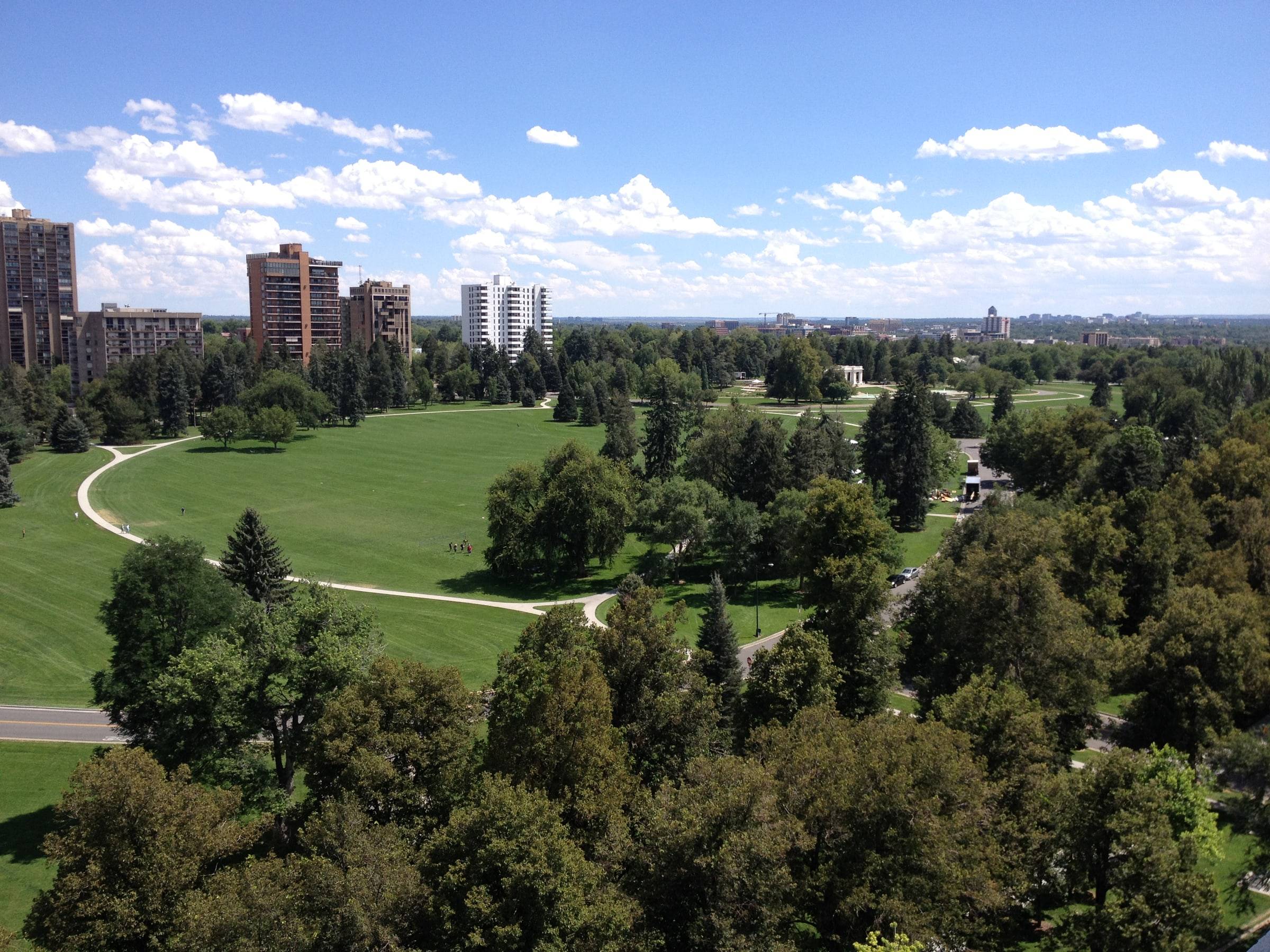 Cheesman Park from above, with mature trees and the Capitol Hill skyline