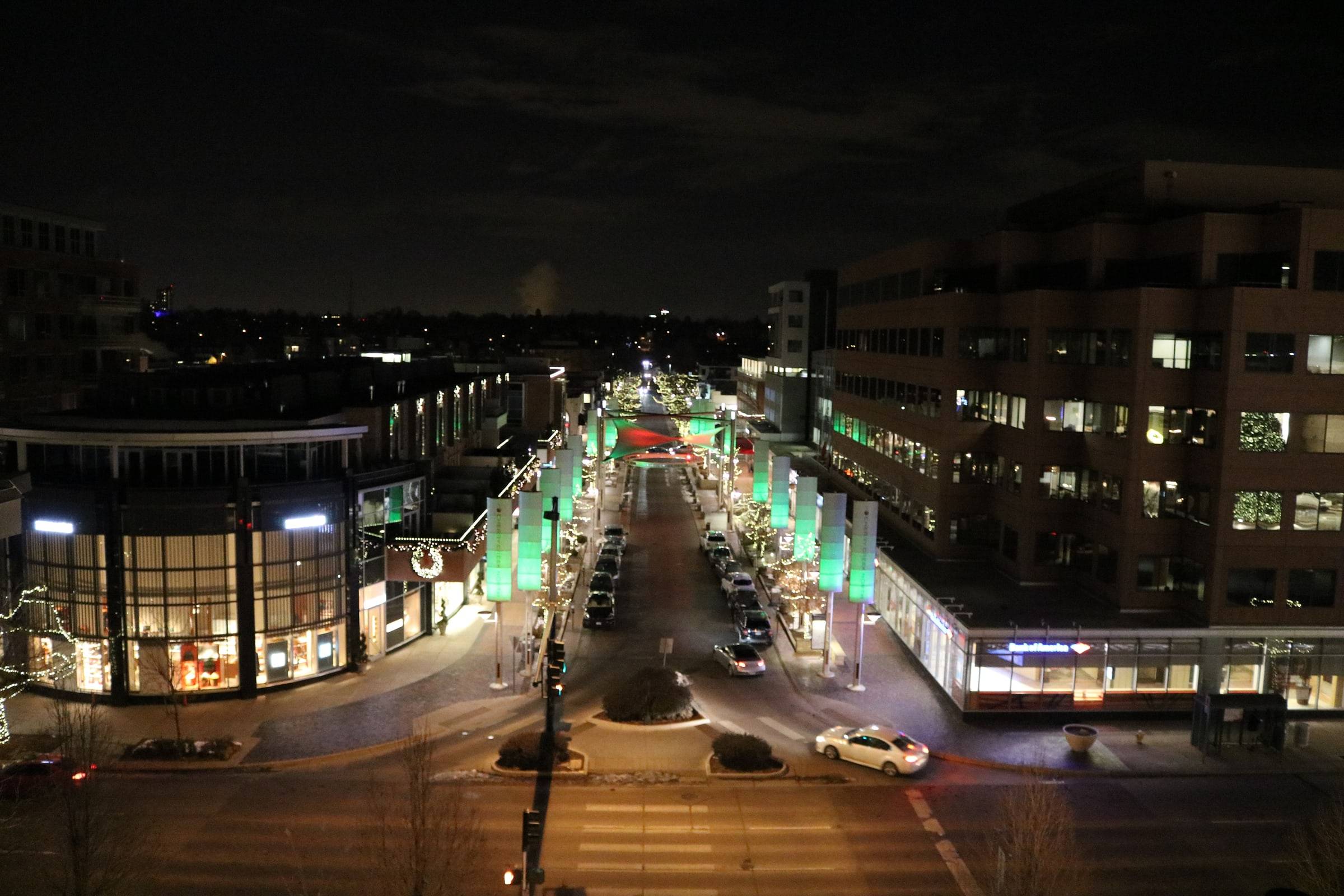Fillmore Place in Cherry Creek North at night, its shops and tree-lined plaza lit for the holidays