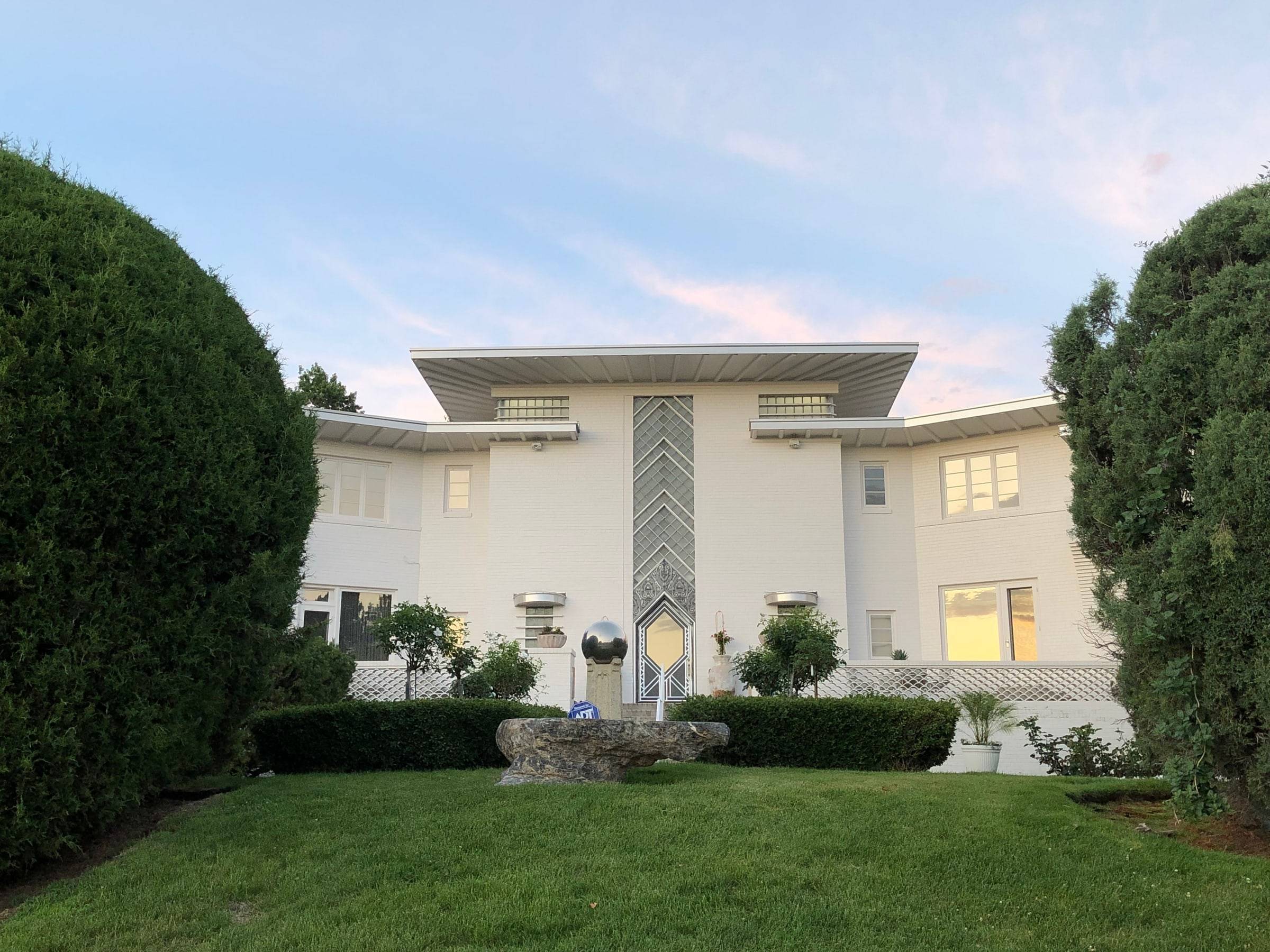 Shangri-La, Hilltop’s landmark Art Moderne residence, framed by mature evergreens and a sweeping lawn